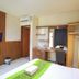 Mirah Hotel & Resort Banyuwangi guest room with bed, TV, desk, and wardrobe