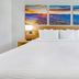 Days Inn Roanoke Near I-81 guest room with king bed and mountain landscape wall art