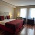 Kenton Palace Buenos Aires guest room with king bed, desk, and large window in Buenos Aires