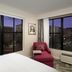 Hampton Inn Huntsville/Village of Providence room with corner windows and city view at dusk