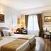 Mediterranean Palace Thessaloniki guest room with twin beds, desk, and window with curtains