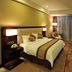 Shenyang Neu International Hotel room in Shenyang with king bed, armchair, and city-view window