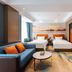 Qinhuangdao Haishanghai International Hotel guest room with two beds, sofa and ocean-themed mural in Qinhuangdao