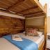 Pousada Soft Brooklin in Sao Paulo bunk bed with wood paneling and neatly made single bed