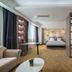 Xiamen Junming Hotel in Xiamen guest room with king bed, seating area, and built-in shelving