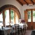 Agriturismo Galea in Riposto dining room with arched doorway, wooden doors, and rustic stone wall