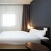Dormy Inn Sendai Annex Natural Hot Spring guest room with bed, TV, and window in Sendai