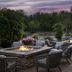 Hilton Garden Inn Cedar Falls outdoor patio with fire pits and wicker seating at dusk
