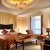 Power Valley International Hotel in Baoding guest room with canopy bed, chaise lounge and chandelier