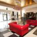 Hotel Royal Baltic 4 Luxury Boutique in Ustka lobby with red tufted sofas, chandelier and checkered floor