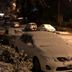 Hosteria La Raclette in San Martín de los Andes, snow-covered cars parked on a street at night