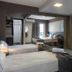 Lym Flat Hotel in Uberlândia with twin beds, desk, seating area and floor-to-ceiling curtains