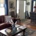 Terrell House B&B in Burnsville living room with leather sofa, coffee table, chair, and hardwood floors