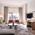 Renaissance Phoenix Glendale Hotel & Conference Center guest room with sofa, TV, desk, and city view
