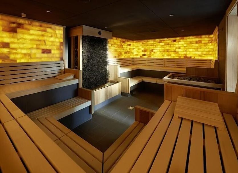 Hotel Bora Hotsparesort in Radolfzell spa sauna with wooden benches and warm backlit stone walls