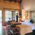 Posada Puerto Bemberg in Puerto Libertad: twin beds, colorful wood headboard, and warm rustic guest room