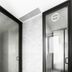 TUVE Hong Kong bathroom with frosted glass shower enclosure and marble-look walls