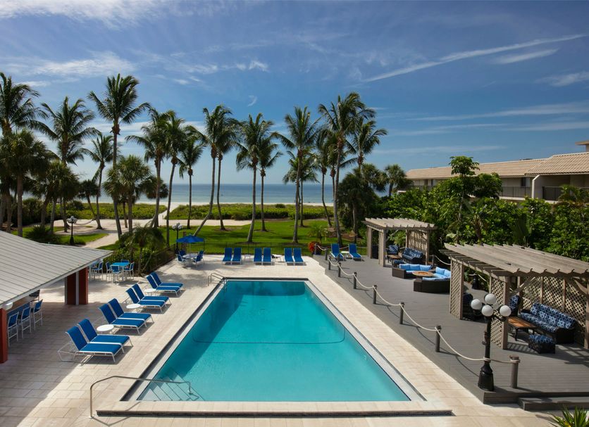 Sanibel Island Beach Resort pool with palm trees and ocean view in Sanibel