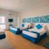 Brisa Marina Beach Resort powered by Cocotel room in Morong with three beds and blue accents
