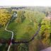 Aerial view of La Quinta Inn & Suites by Wyndham North Platte with grassy grounds and a small stream