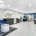 Comfort Inn Greenville - Haywood Mall lobby with blue sofa, reception desk and hallway in Greenville