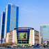 Jinan Jier Hotel in Jinan with tall blue towers and a street-level hotel entrance