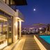 Lawhill Luxury Apartments in Cape Town rooftop pool terrace at dusk with city views and lounge area