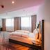 Premier Inn Karlsruhe City Am Wasserturm room with bed, armchair and large windows in Karlsruhe