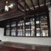 Hotel Duomo And Suites in Kampala bar area with glass-front cabinets and bottles above the counter