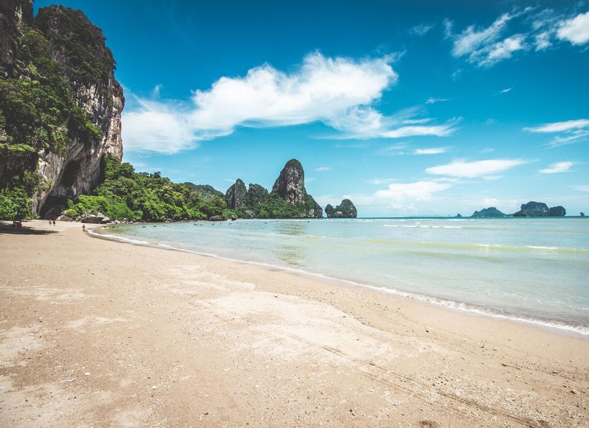 Seashell Resort Krabi beachfront view of a sandy beach, calm turquoise sea, and limestone cliffs in Krabi