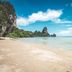 Seashell Resort Krabi beachfront view of a sandy beach, calm turquoise sea, and limestone cliffs in Krabi