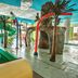Towers at North Myrtle Beach indoor water park with green slides and palm-tree theming