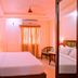 Hotel Gulshan International in Kolkata guest room with double bed, mirrored wardrobe, and window curtains