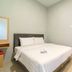 The Nagoya Plasa Redpartner in Batam: simple double bed room with white linens and wall-mounted TV