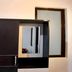 Infinite Residence Bandung room with dark wardrobe, mirror and frosted window