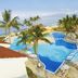 Samba Vallarta in Nuevo Vallarta with palm-lined pool, ocean view, and lounge chairs