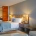 Grand Velas Los Cabos guest room with king bed, bedside lamps, and neutral modern decor in San José del Cabo