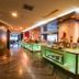 Swiss-Belhotel Mangga Besar in Jakarta restaurant buffet with glowing green counters and warm lighting