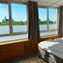 Hotel Credible Nijmegen room with bed and large windows overlooking the city skyline