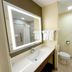 Sonesta Essential Hotels Overland Park bathroom with illuminated mirror, vanity, toilet and tub-shower