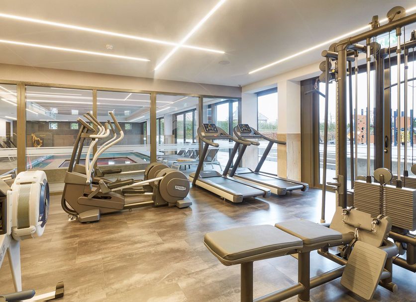 Van der Valk Hotel Breda gym with treadmills, elliptical machines and large windows in Breda