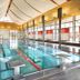 Asia Hotel & Spa Leoben indoor pool with lane markers and a high ceiling in Leoben