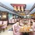 The Vijay Park Chennai dining room in Chennai with pink velvet chairs, marble tables and ornate ceiling lights