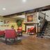 Red Roof Inn & Suites Knoxville East lobby seating area with staircase in Knoxville