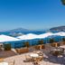 Grand Hotel Europa Palace in Sorrento with terrace seating, white umbrellas, and sea view to the island