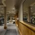 The Lalit London gym with treadmills, weights, and mirrored walls in London