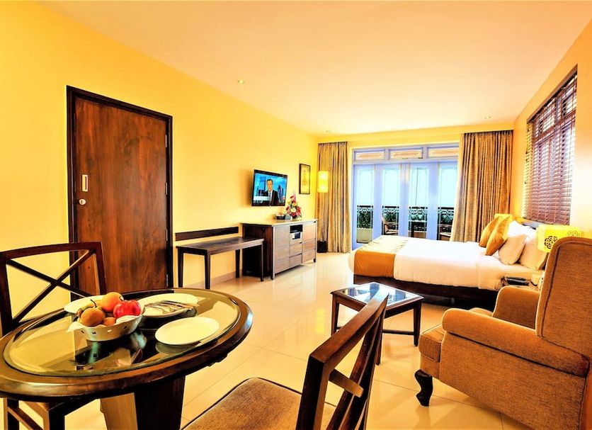 Varanda Do Mar Panaji guest room with balcony sea view, bed, sofa, and sitting area