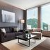 Courtyard by Marriott Seoul Myeongdong suite with sofa, city and mountain view, and N Seoul Tower view