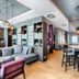 Premier Inn Lübeck City Centre lobby with gray sofa seating, high tables, and hanging pendant lights in Lübeck
