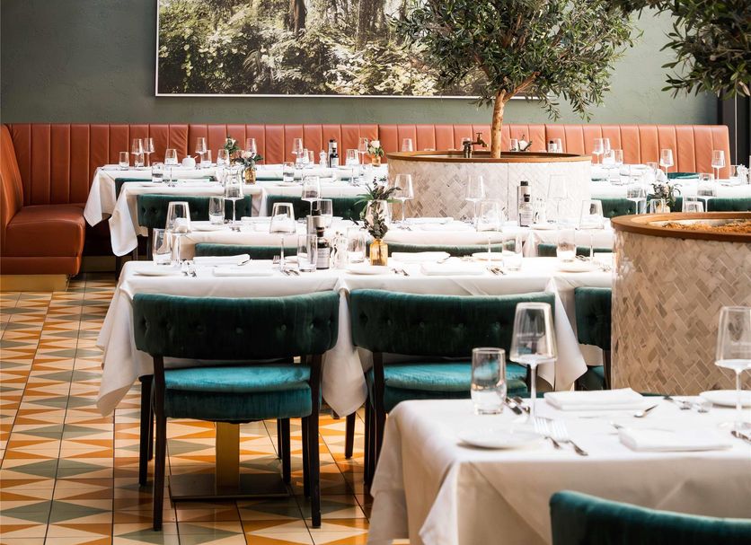 The Wellem Düsseldorf dining room with oversized woven pendant lights and set tables